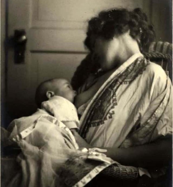 old photo of mother breastfeeding her baby