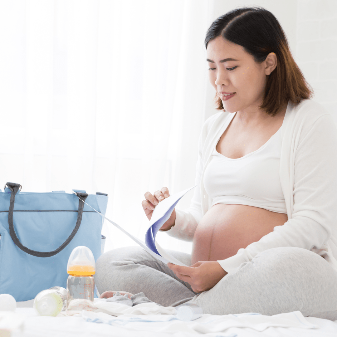pregnant woman studying a document while preparing for childbirth