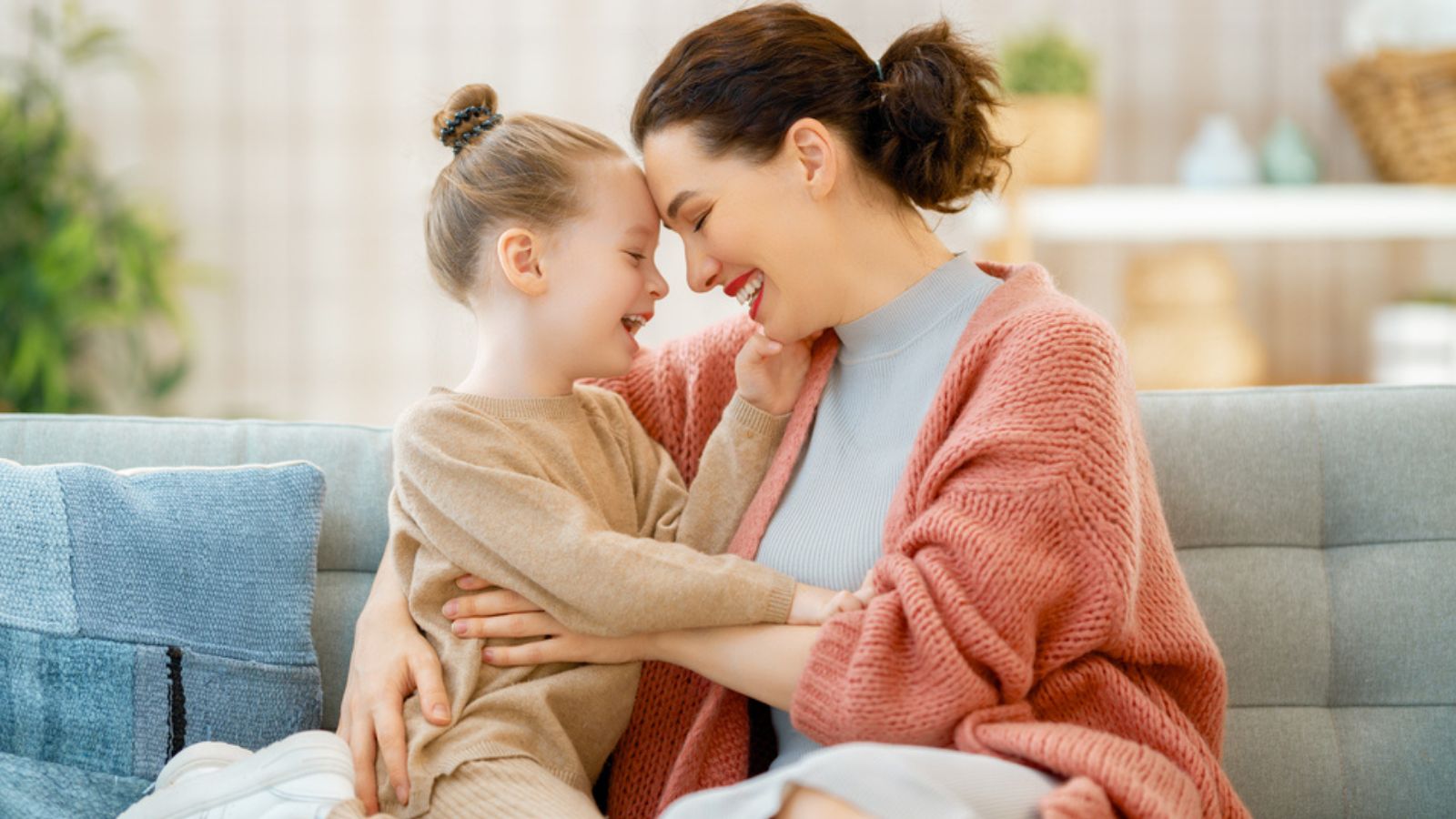 Mom and her daughter child girl are playing smiling and hugging at home.jpg
