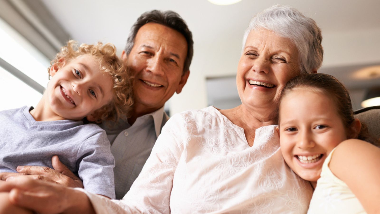 Grandparents are the best. Portrait of grandparents with their grandchildren at home.jpg